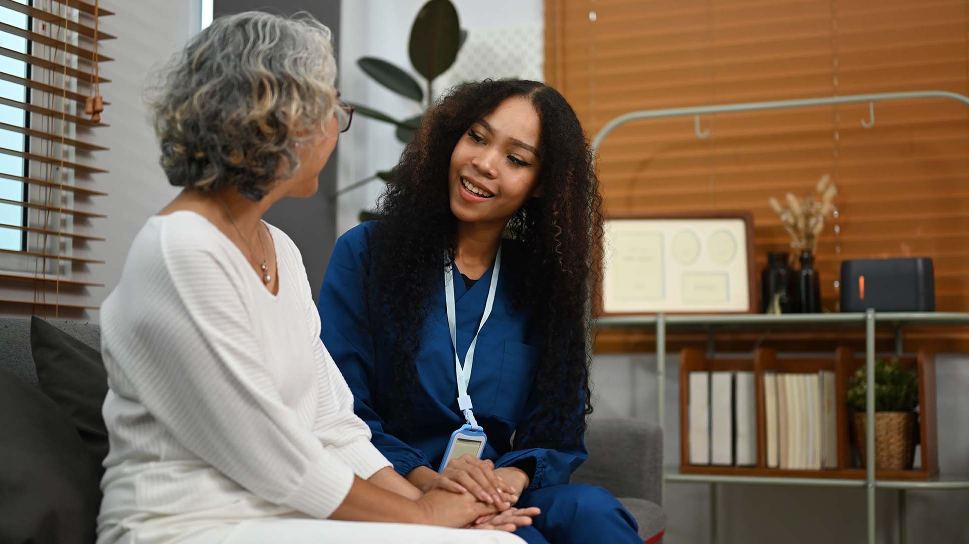 Image Of Caring Female Caregiver Talking To Senior Woman. Elderl